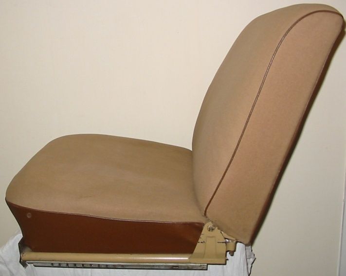 Beige car seat, side view, on tan base with dark brown trim.