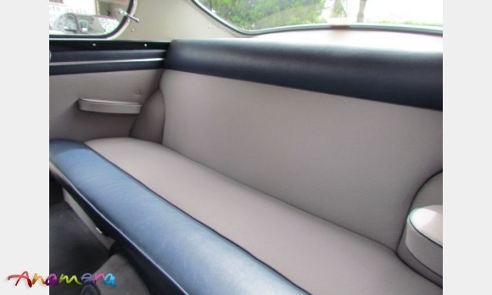 Interior car back seat; gray and blue upholstery.