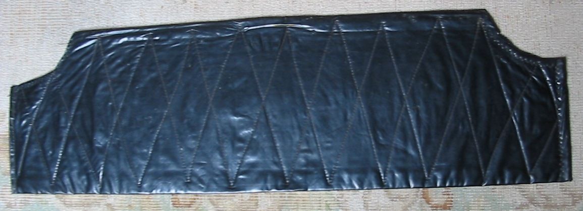 Black padded headboard with stitched diamond pattern.