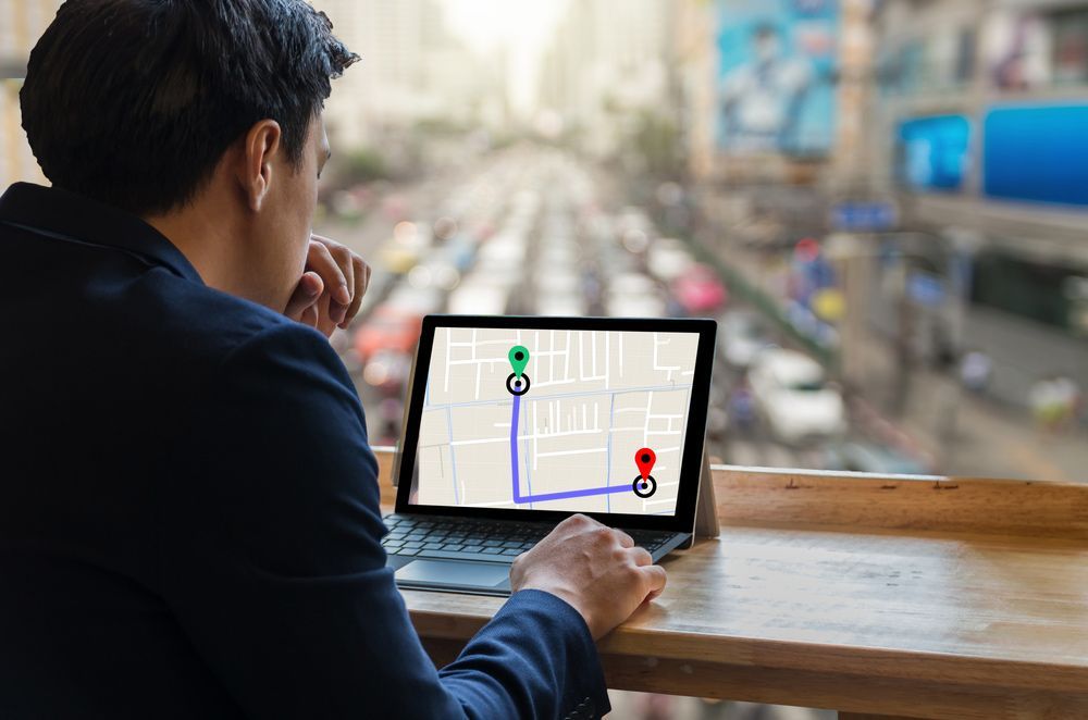 A Man Is Sitting At A Table Using A Laptop Computer  — Surveillance NQ In Cairns, QLD
