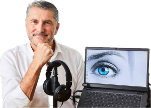 A Man With Headphones And A Laptop With A Blue Eye On The Screen — Surveillance NQ In Airlie Beach, QLD