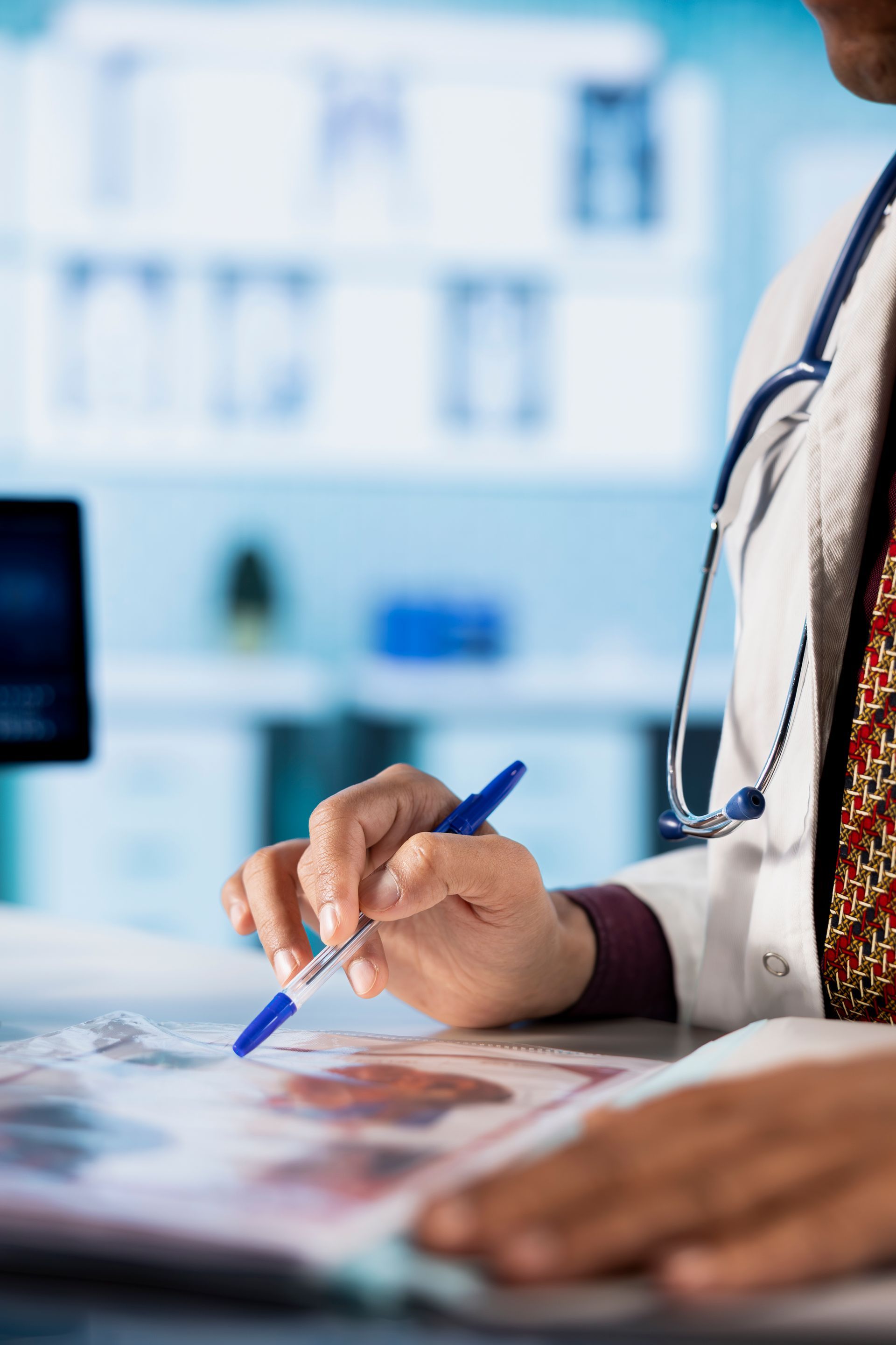 Doctor writing notes on a clipboard in a bright medical office
