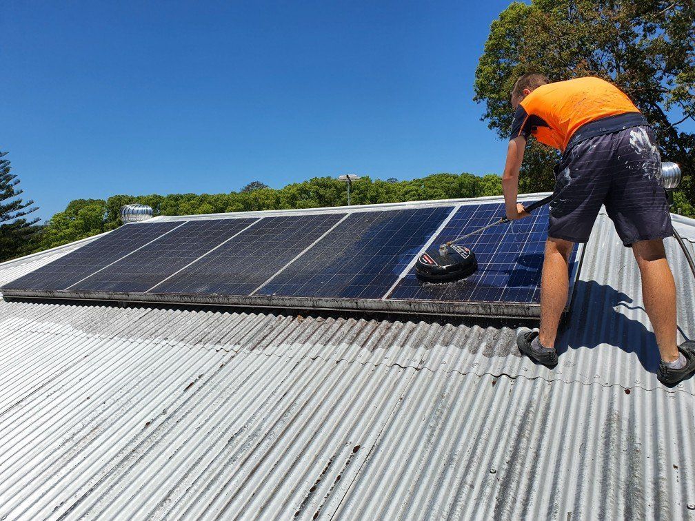 man cleaning solar panel