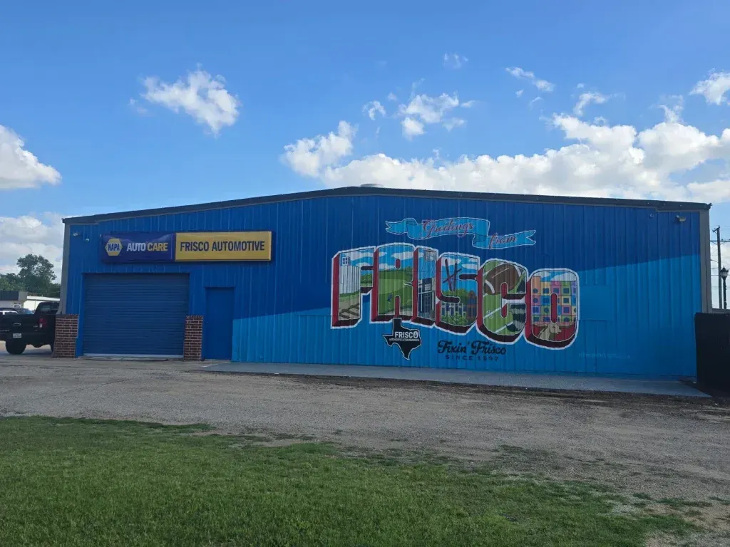 Blue building with colorful “Chicago” mural under a partly cloudy sky. | Frisco Automotive & Transmission