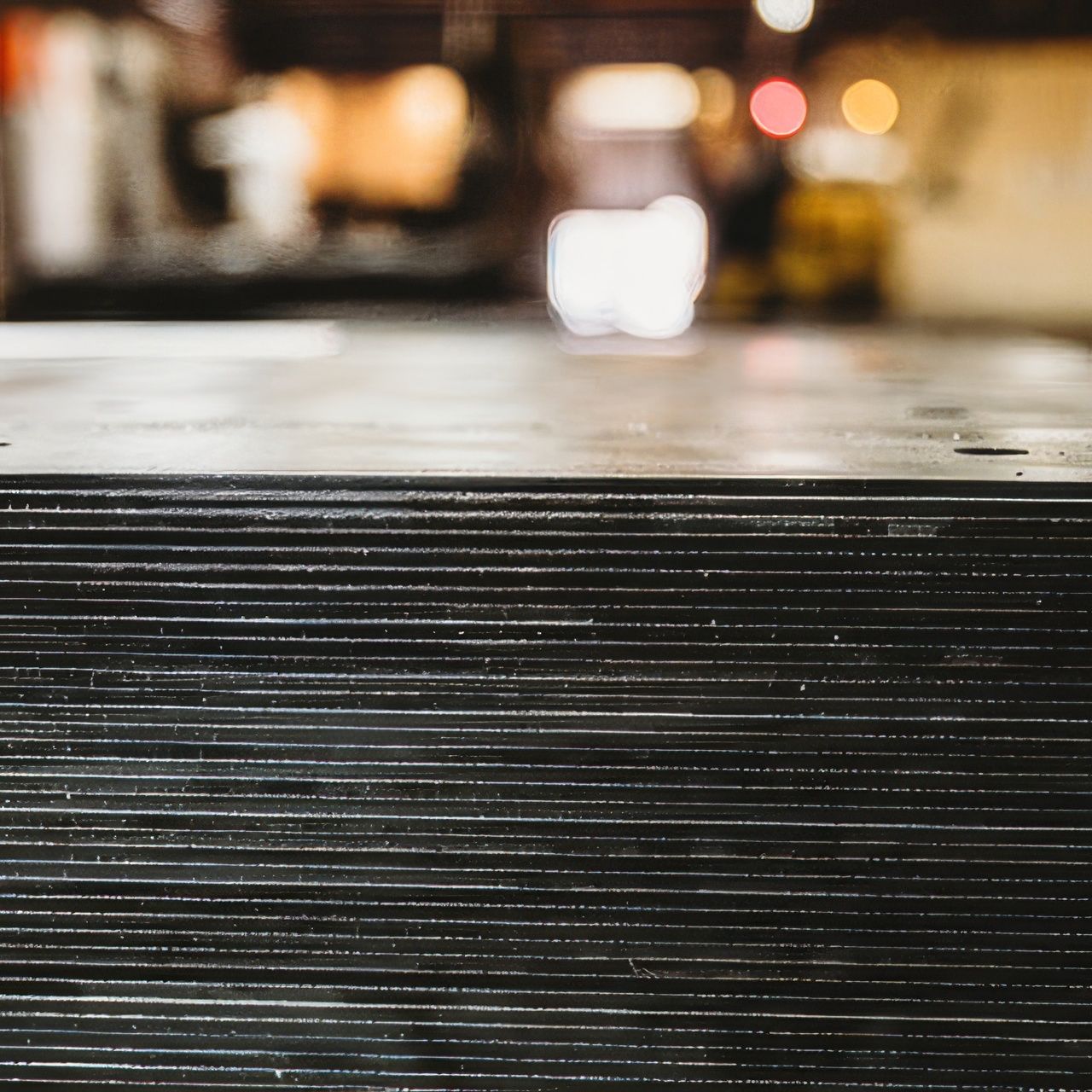 A close up of a stack of metal sheets in a factory.