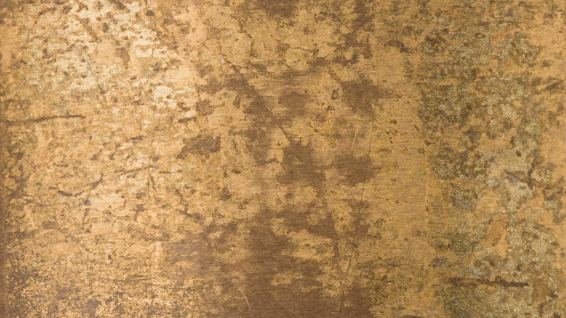 A close up of a gold colored marble texture.