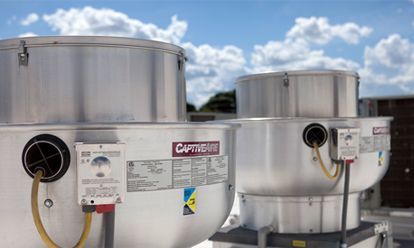 Two large aluminum containers are sitting on top of each other on a roof.