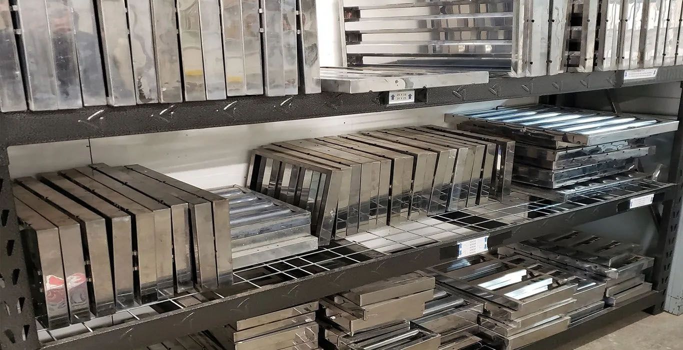A shelf filled with lots of metal pieces on it.