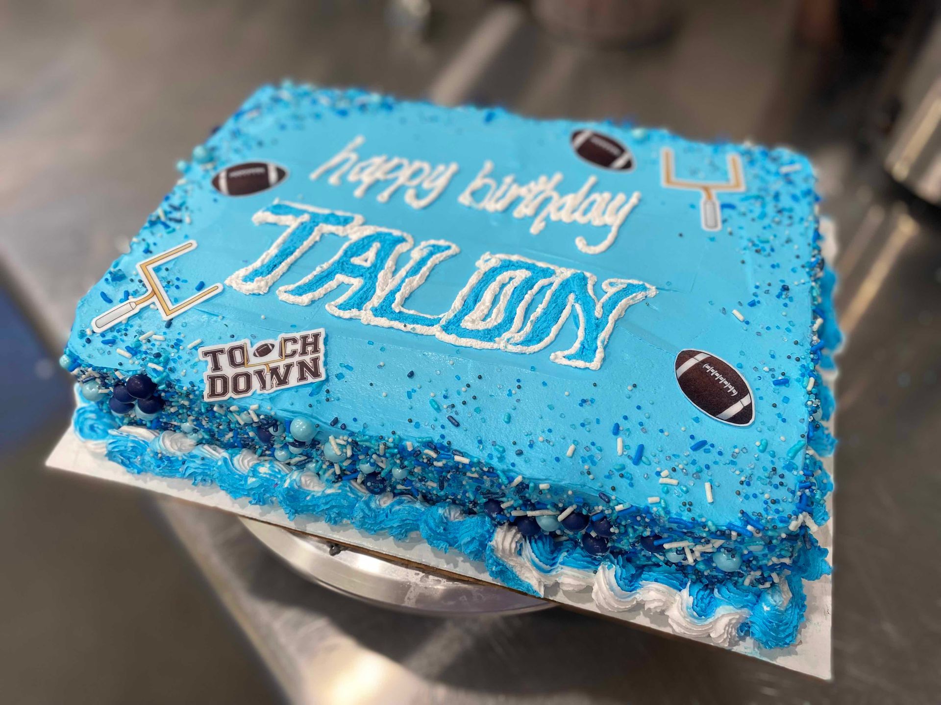 A blue rectangular birthday cake for