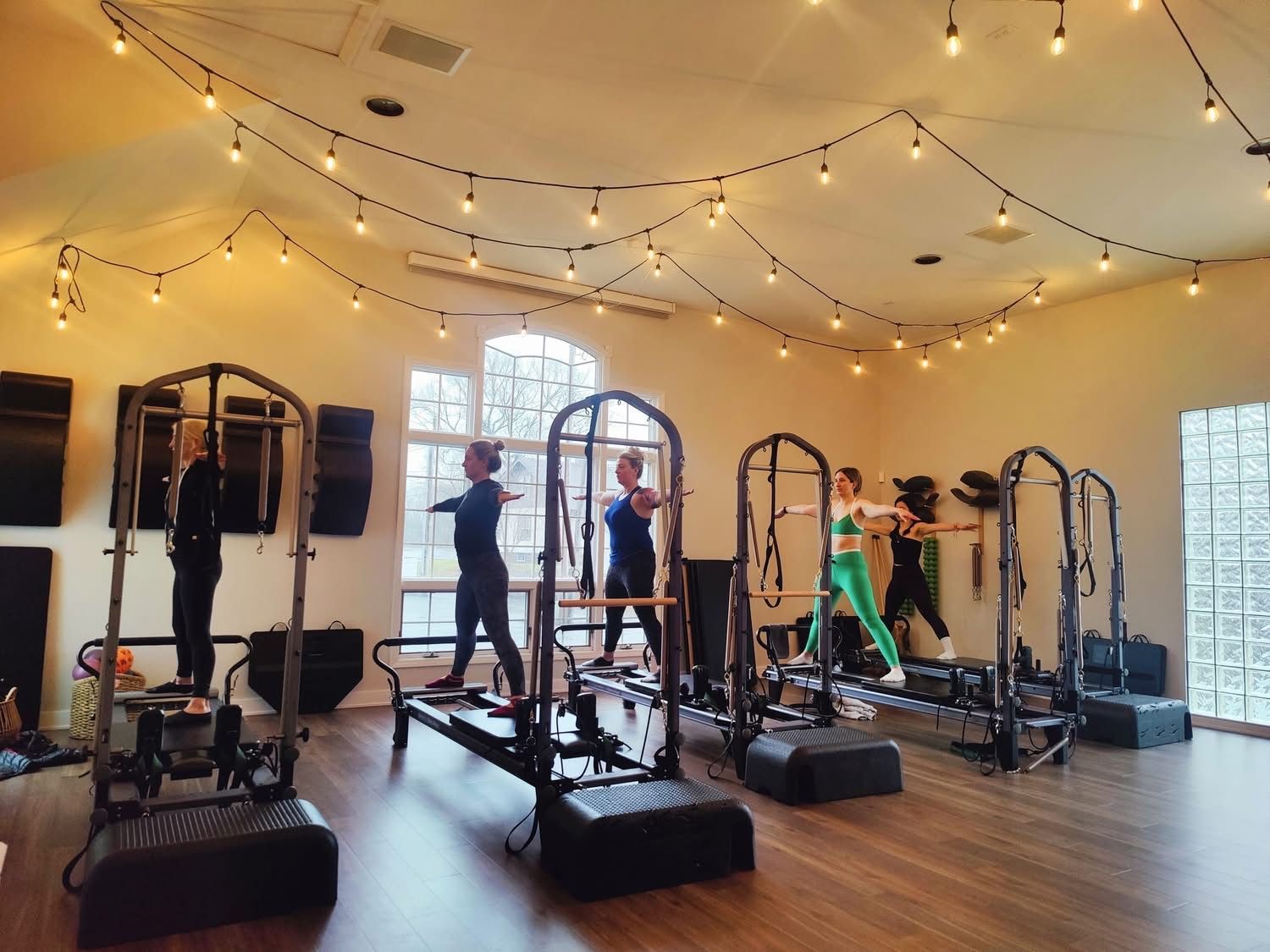 Katie is performing a pilates movement on a reformer in the Rise Integrative studio