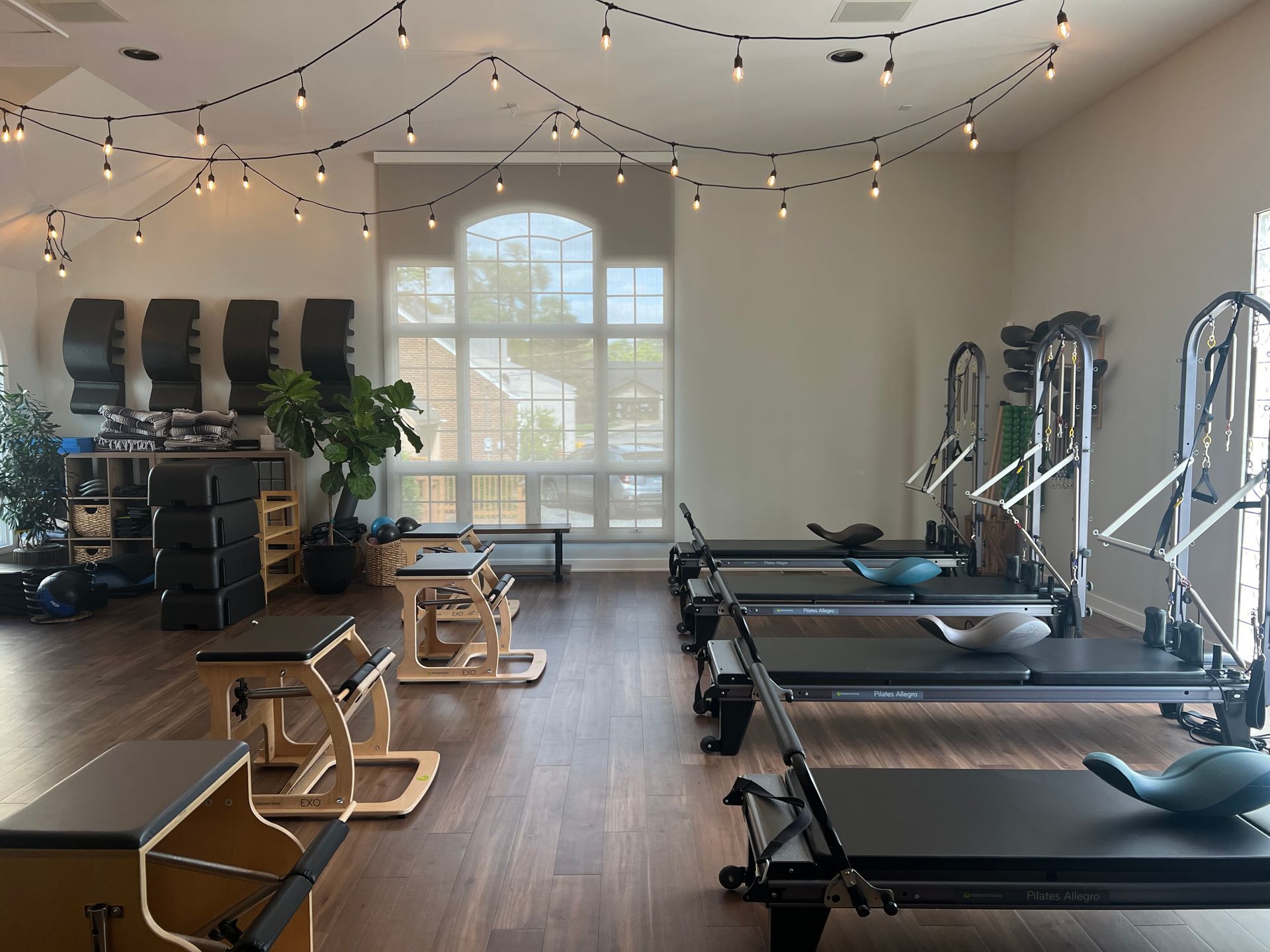 A large room with pilates equipment and natural lighting with modern decor
