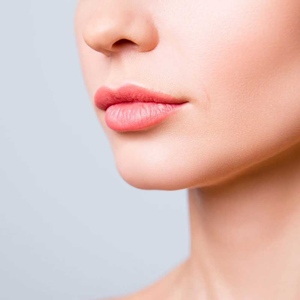 a close up of a woman 's face with pink lips
