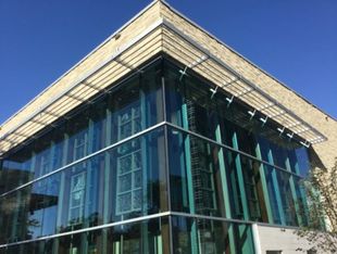 Photo of building's exterior, with massive glass windows.
