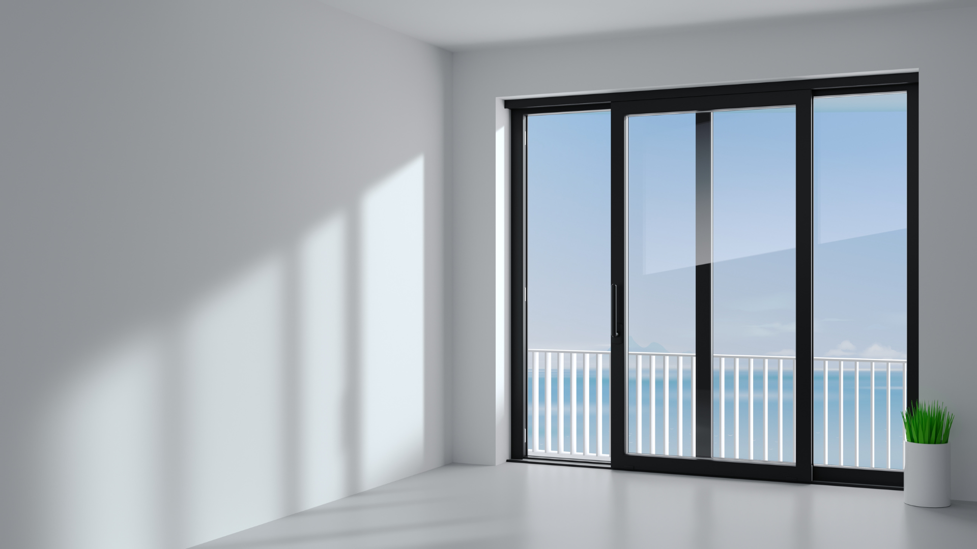 A minimalist room with white walls and floors, featuring a large black sliding glass door leading to a balcony with a sea.
