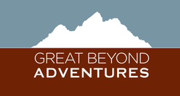 A mountain range silhouette in white against a blue sky above the brown text 