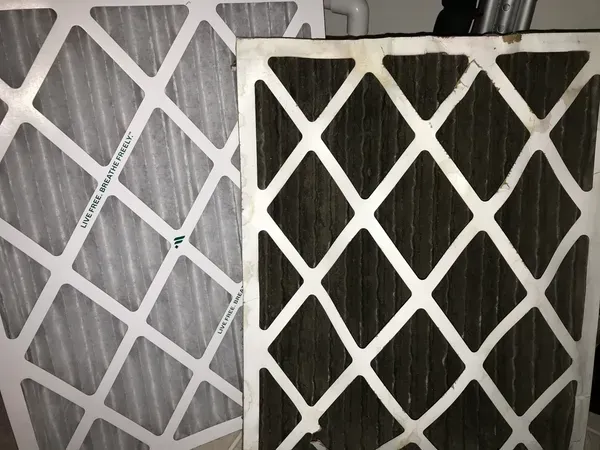 Two white diamond-patterned air filters, one light gray and one black, overlapping side by side