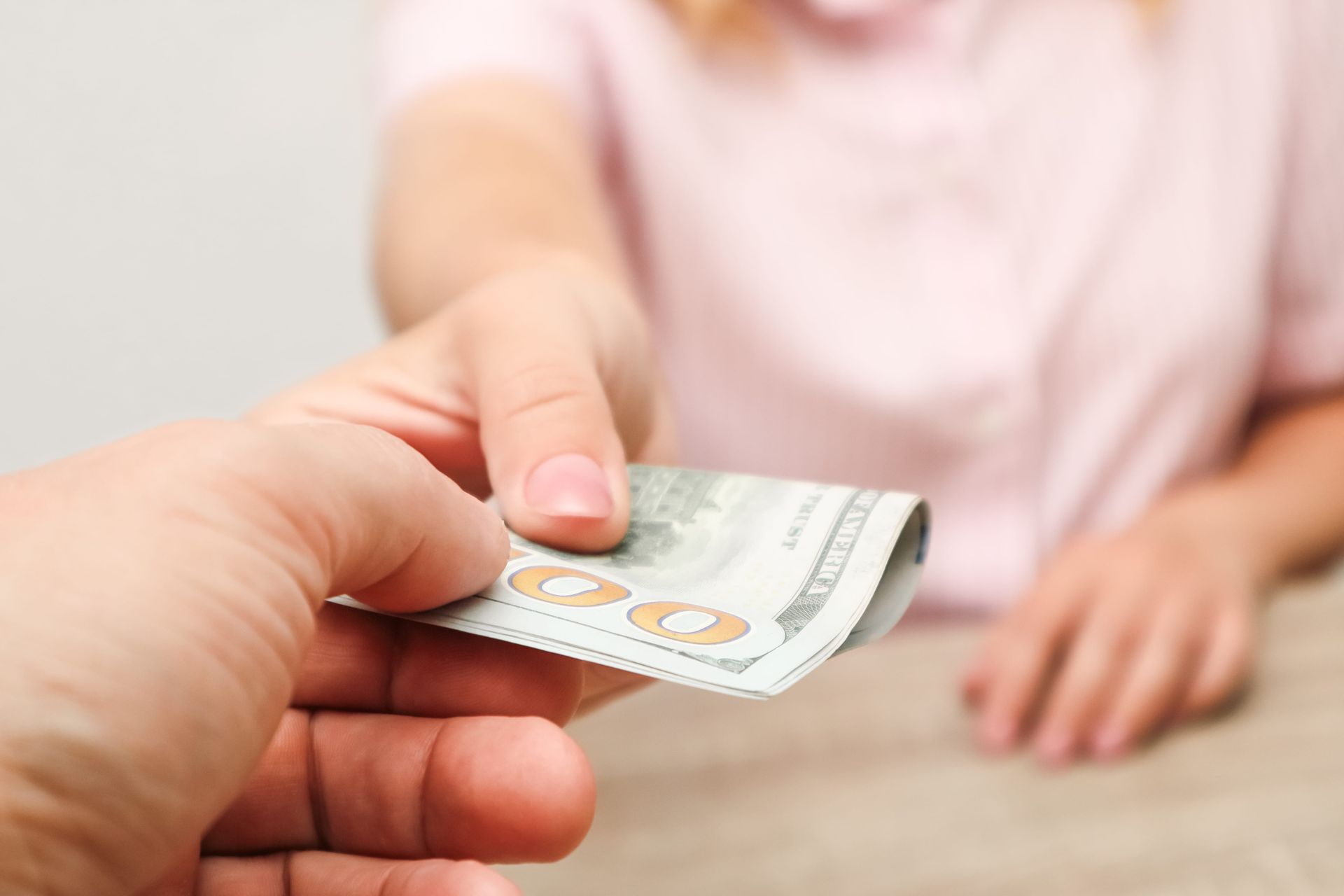 Person handing cash to another over a table