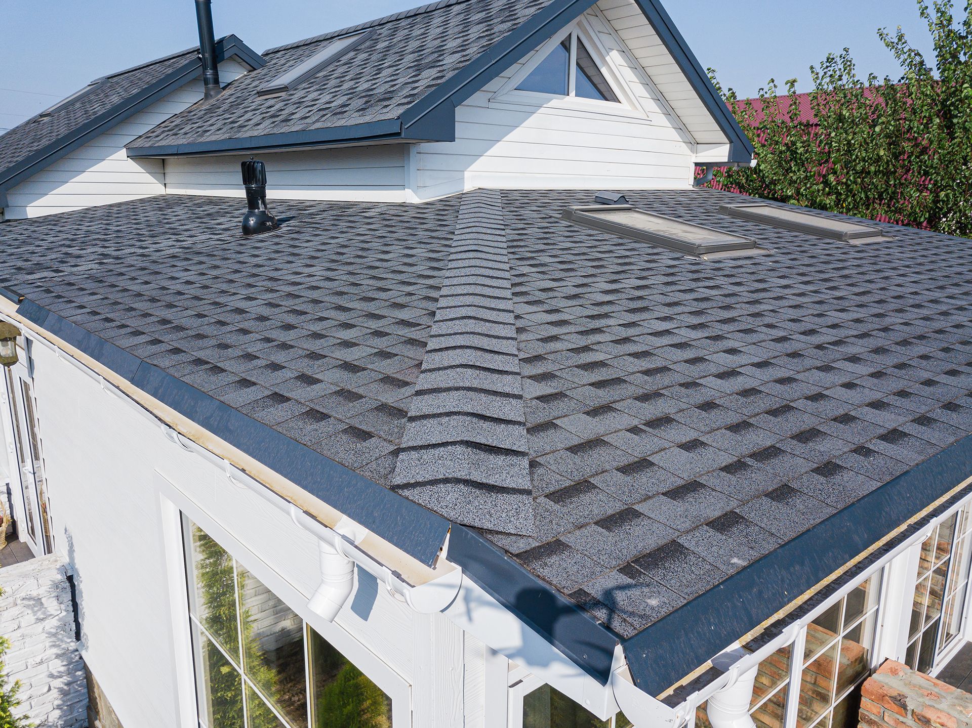 An aerial view of a house with a gray roof.