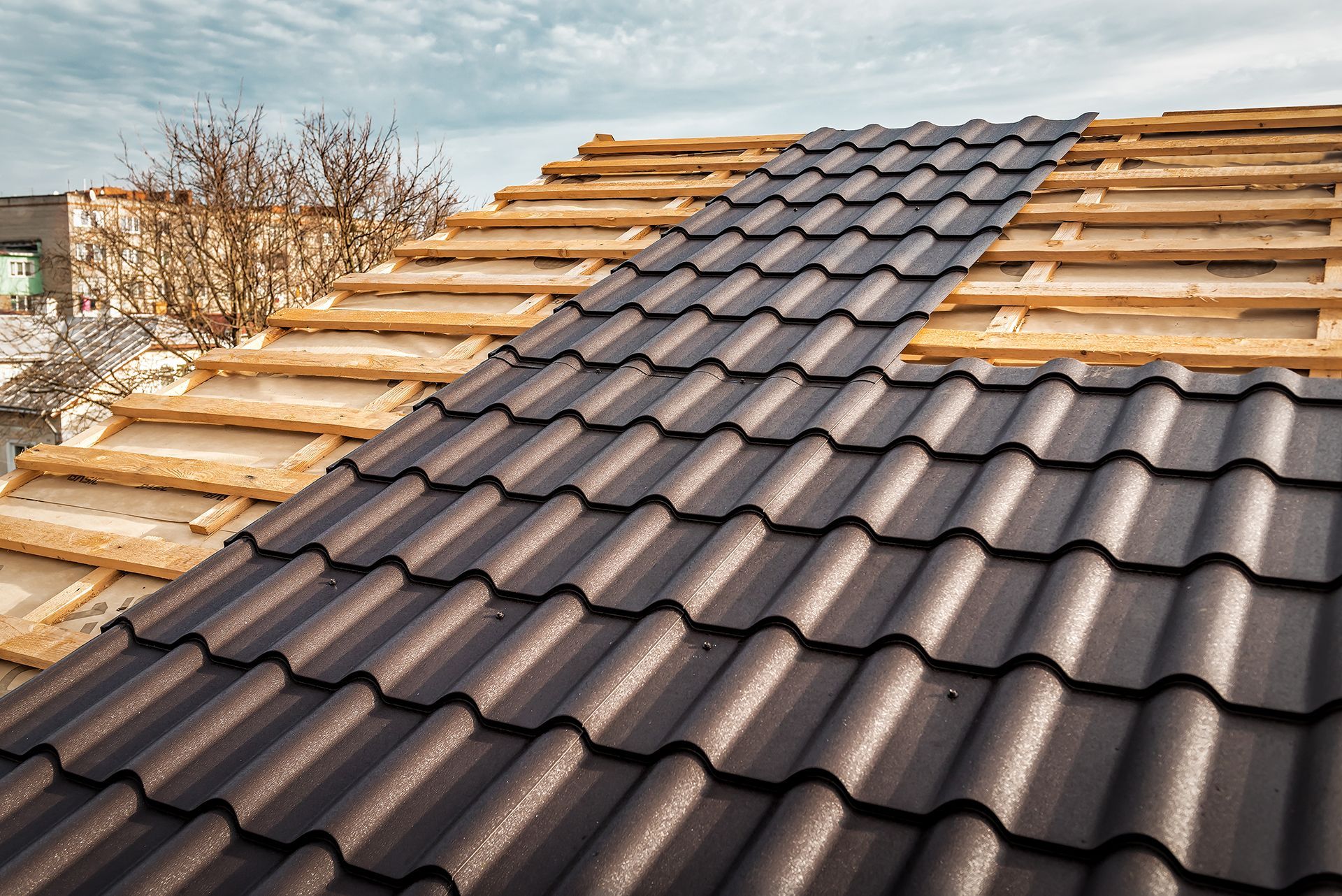 A roof with a lot of tiles on it is being built.