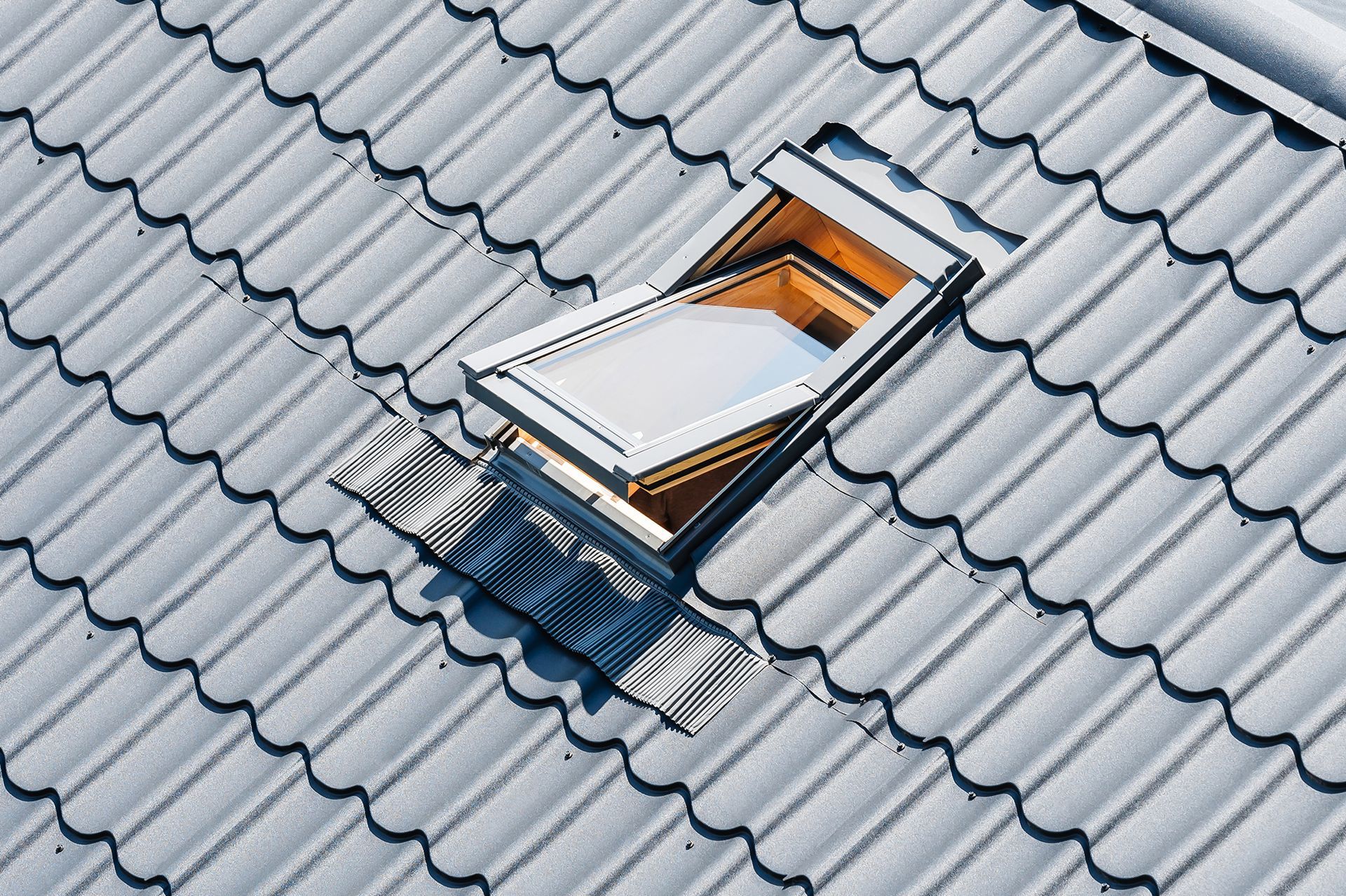 There is a skylight on the roof of a house.