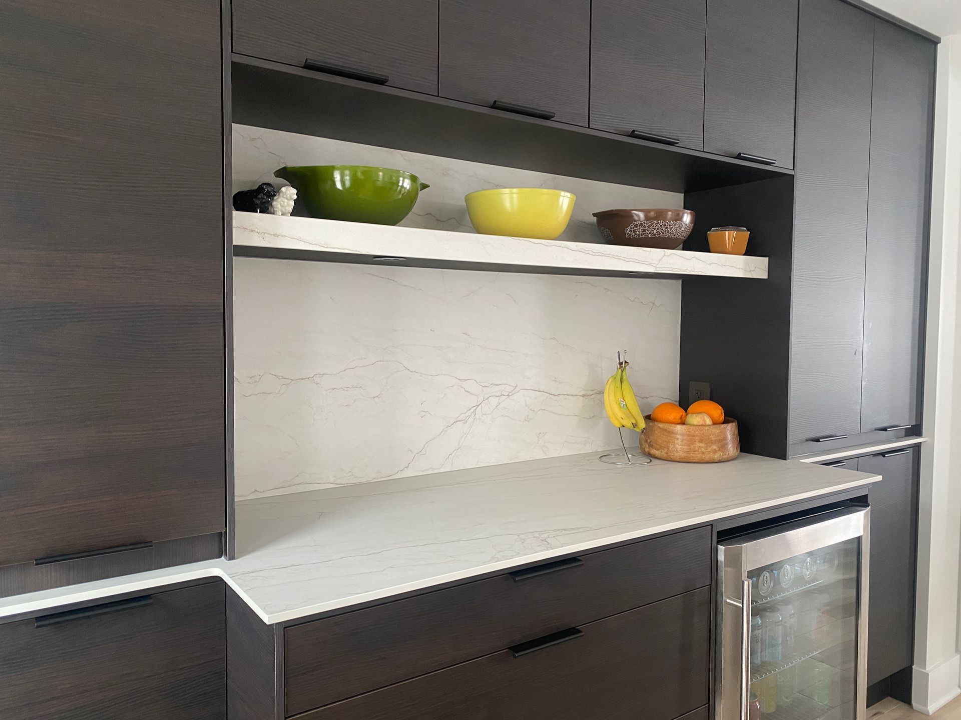 A kitchen with stainless steel appliances and a refrigerator.