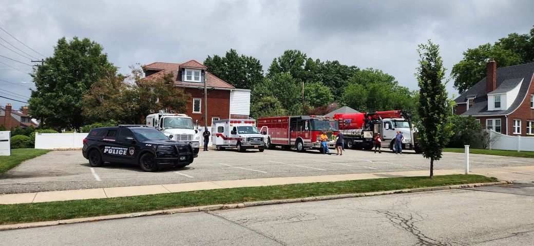 New Kensington Police K-9 cruiser, EMS ambulance, fire truck, and municipal utility trucks parked in lot for Touch a Truck event