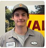 A person wearing a grey work uniform with a 
