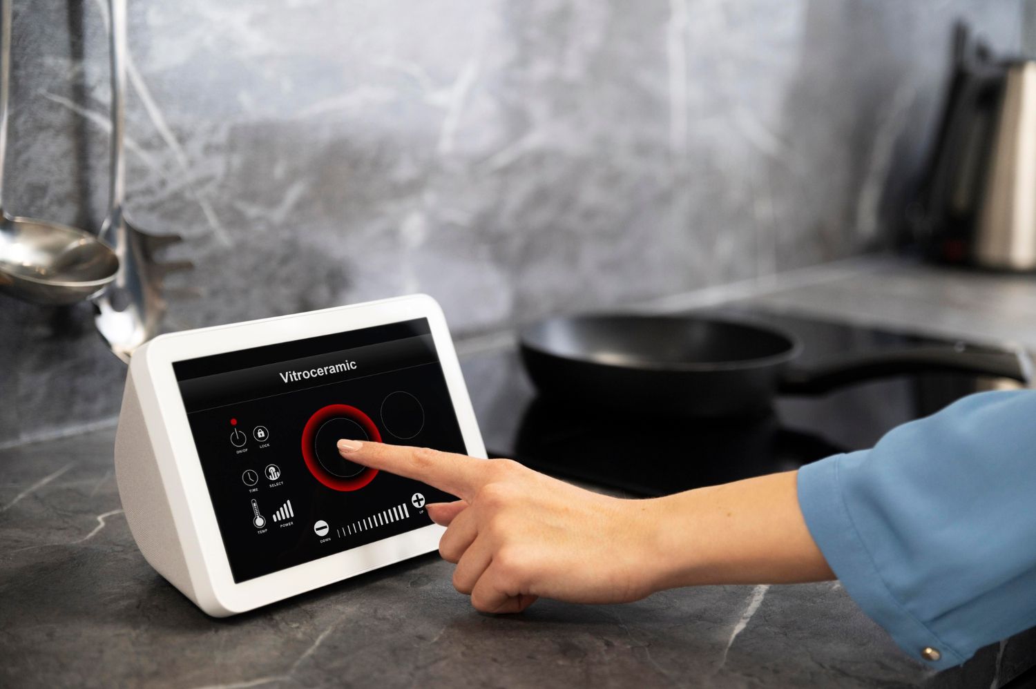 A person uses their finger to select an option on a white smart home display screen placed on a kitchen counter.