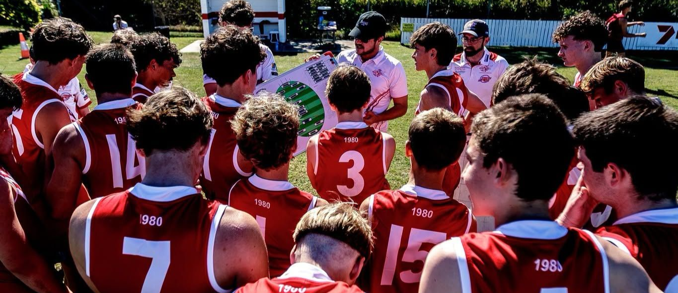YeppoonSwans senior women standing in a circle with their arms around each other - listening to their captains speech prior to the start of the game