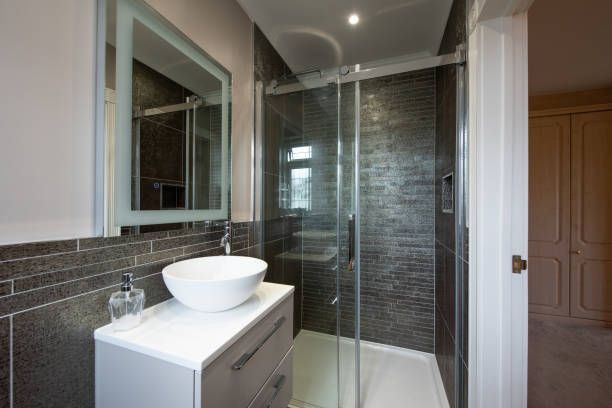 A bathroom with a sink and a walk in shower.