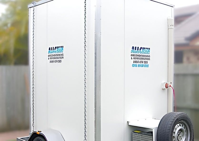 A White Trailer With Two Doors, Likely Containing Bathrooms — Allchin Airconditioning & Refrigeration Electrical in Caloundra, QLD