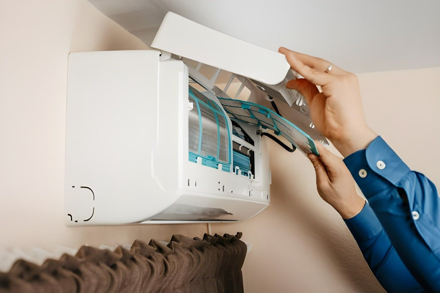 Person Removing the Filter from A White Air Conditioner — Allchin Airconditioning & Refrigeration Electrical in Caloundra, QLD