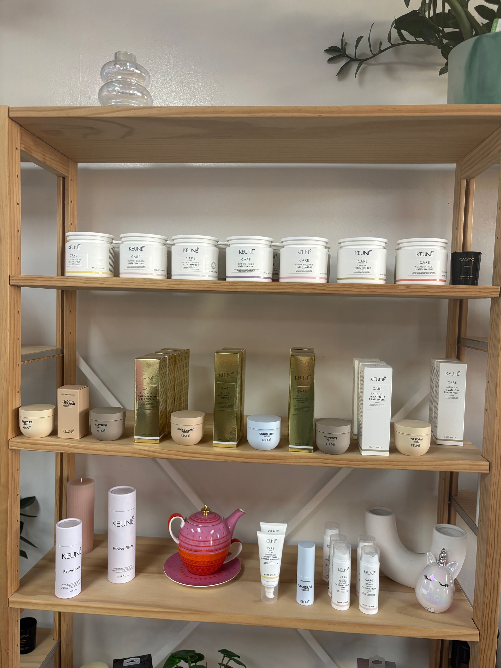 Wooden shelf displaying assorted jars, tubes, and bottles of skincare or beauty products