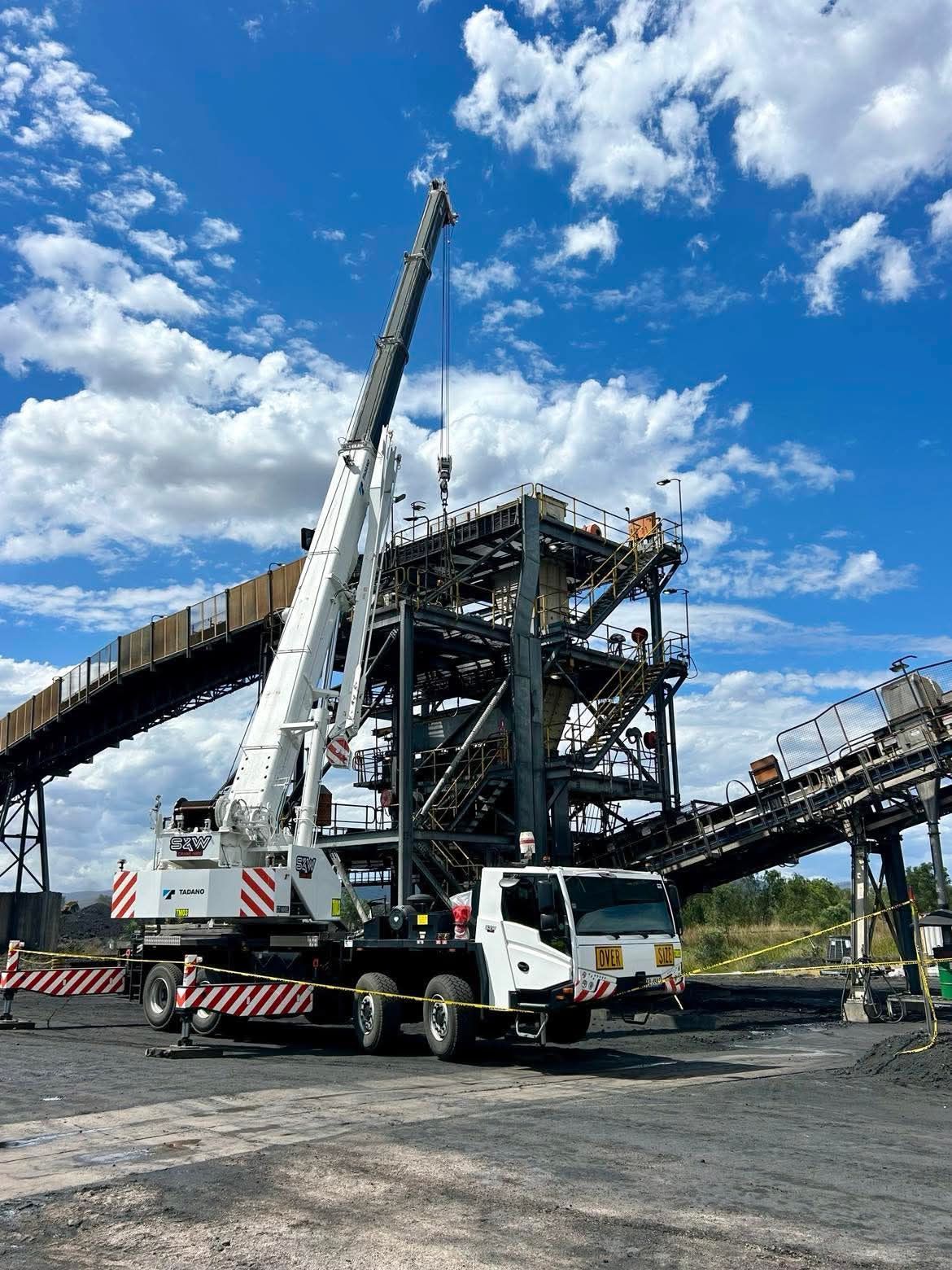 A Large Rock Sitting On Top Of A Cliff Overlooking The Ocean — S & W Crane Hire In Whitsundays, QLD