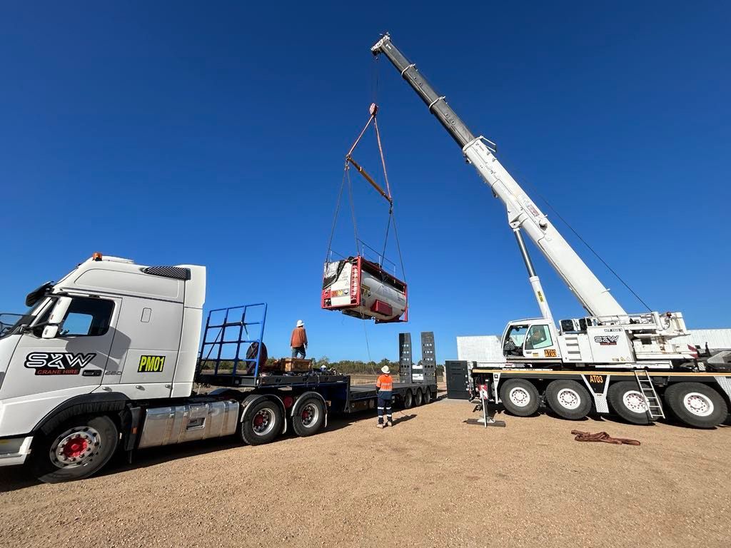 A Tree Trunk Is Sitting Next To A River — S & W Crane Hire In Collinsville, QLD