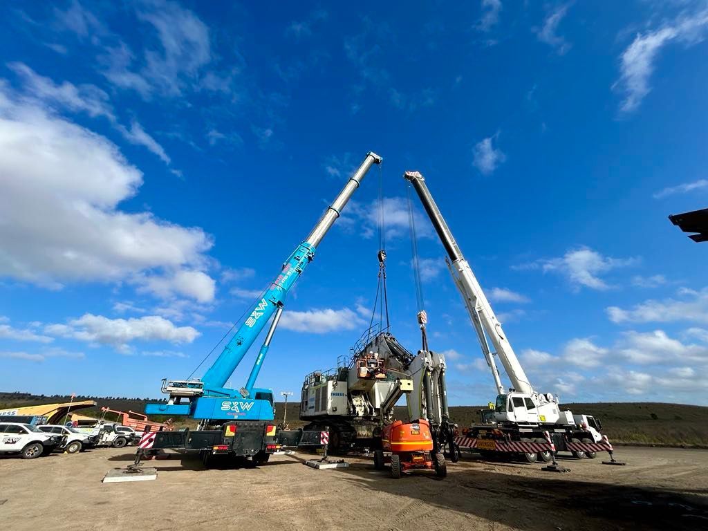 An Aerial View Of A City At Sunset With A River Running Through It — S & W Crane Hire In Collinsville, QLD
