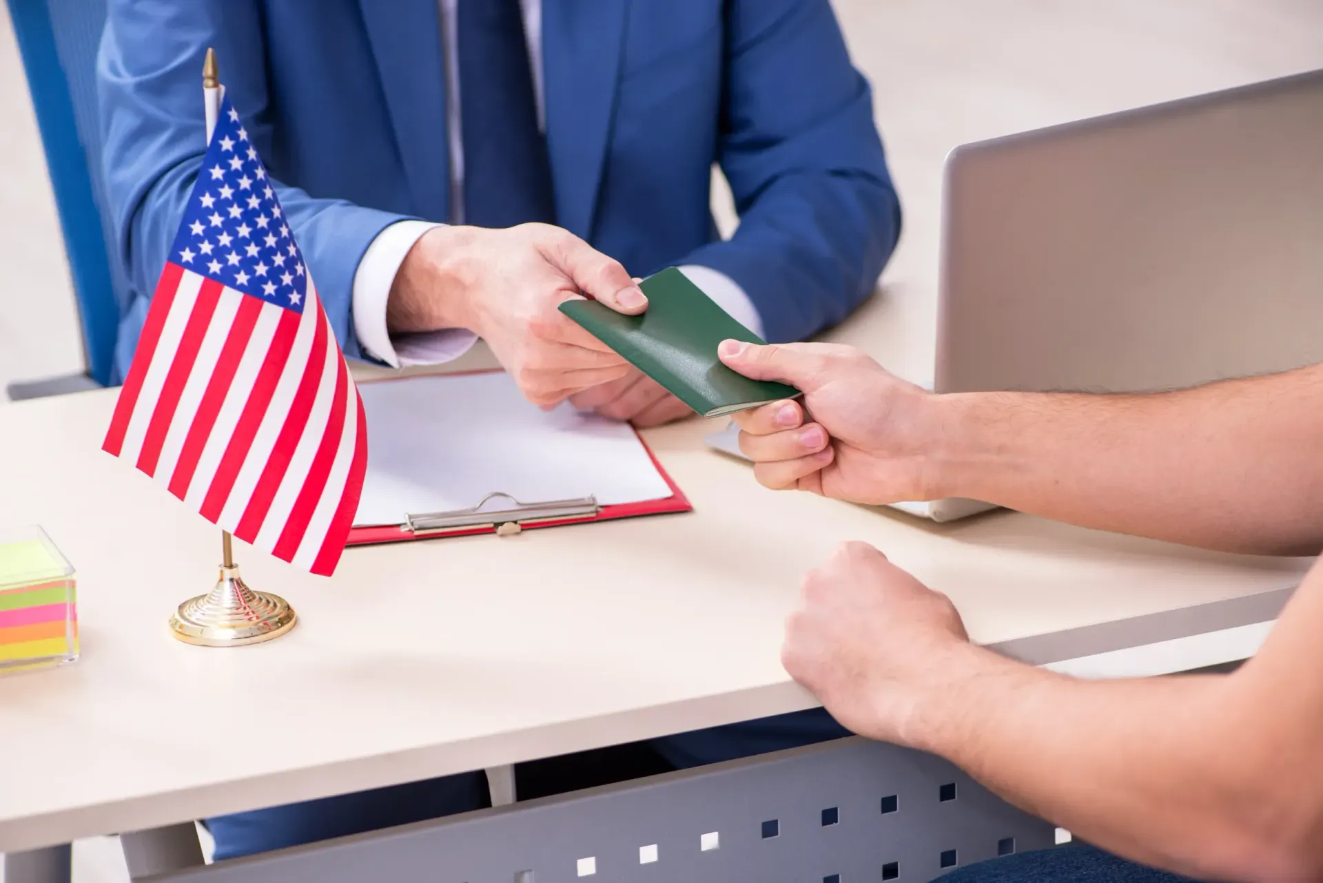 A man is giving a passport to another man.