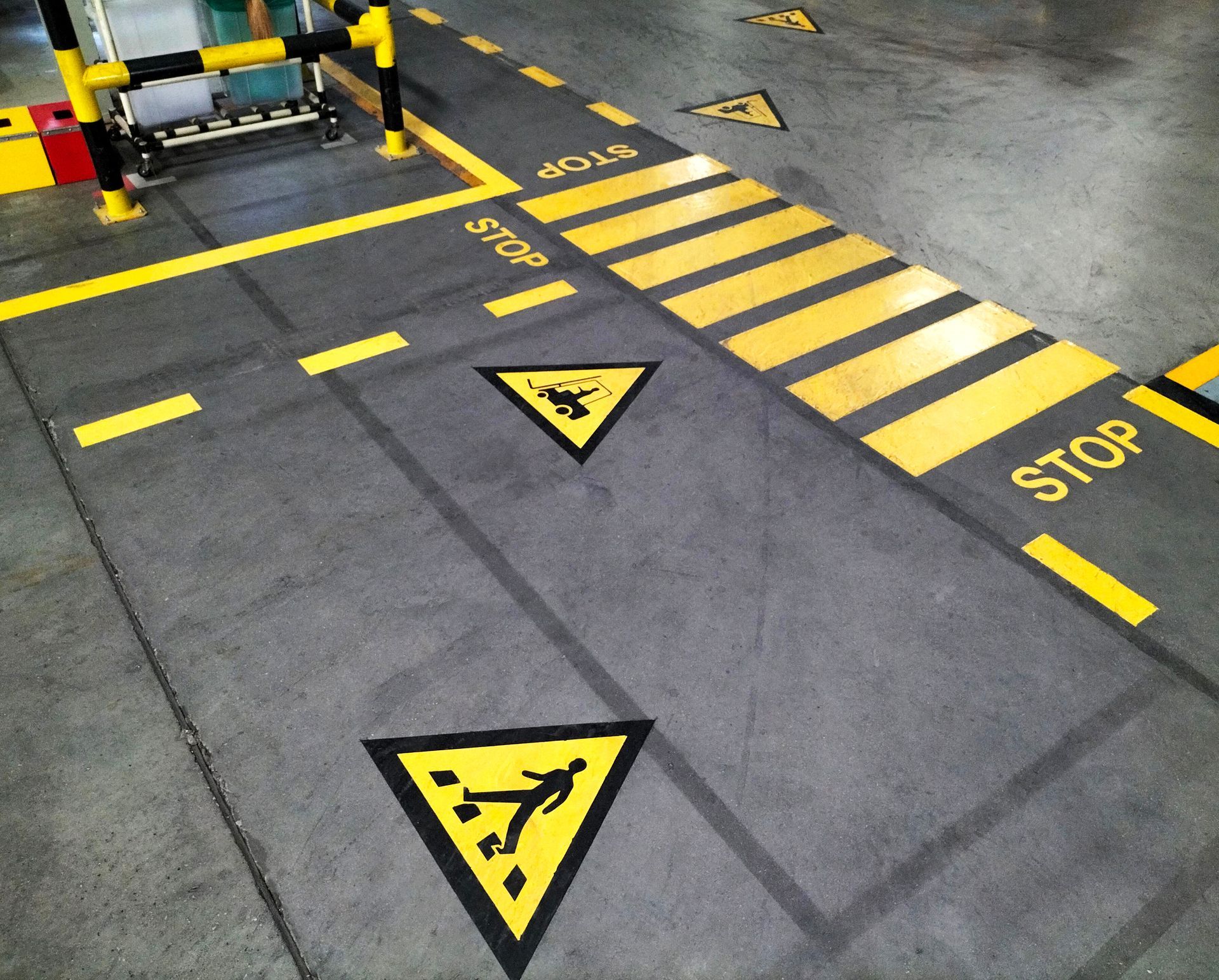 Warehouse floor safety striping highlighting pedestrian crossing areas and forklift safety zones. Warehouse floor safety striping highlighting pedestrian crossing areas and forklift safety zones.