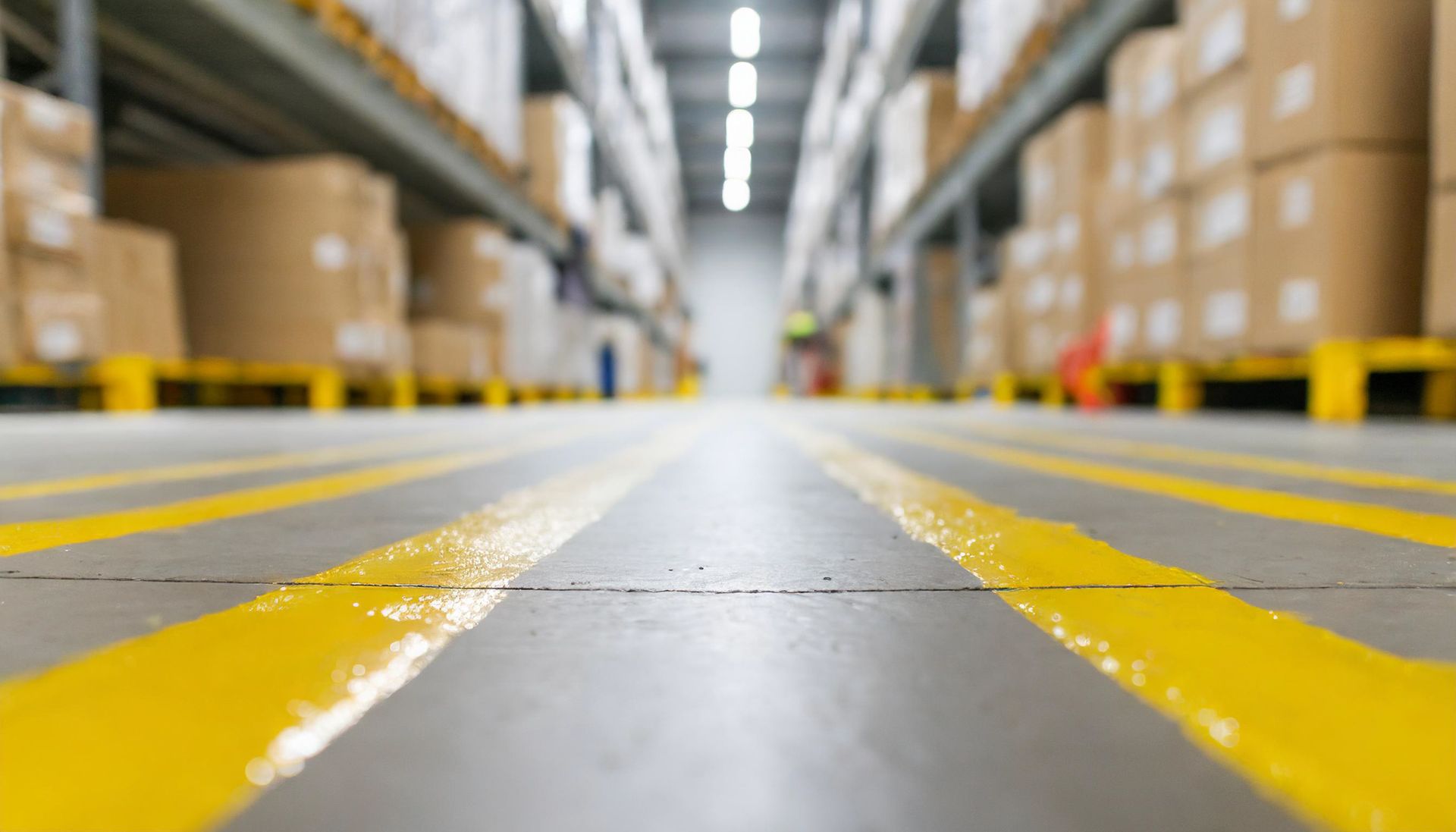 A modern warehouse floor with yellow markings on the floor A modern warehouse floor with yellow markings on the floor
