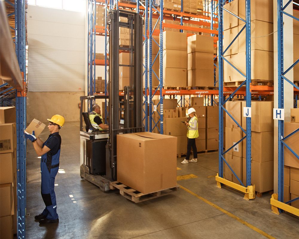 Warehouse workers move inventory with forklifts, placed with safety striping by Warehouse Equipment Solutions in Desoto, TX. Warehouse workers move inventory with forklifts, placed with safety striping by Warehouse Equipment Solutions in Desoto, TX.