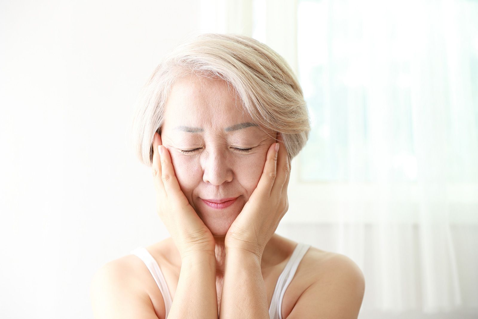 Woman With Hands On Cheek | Lake Geneva, WI | Bare Essentials Laser and Electrolysis Woman With Hands On Cheek | Lake Geneva, WI | Bare Essentials Laser and Electrolysis