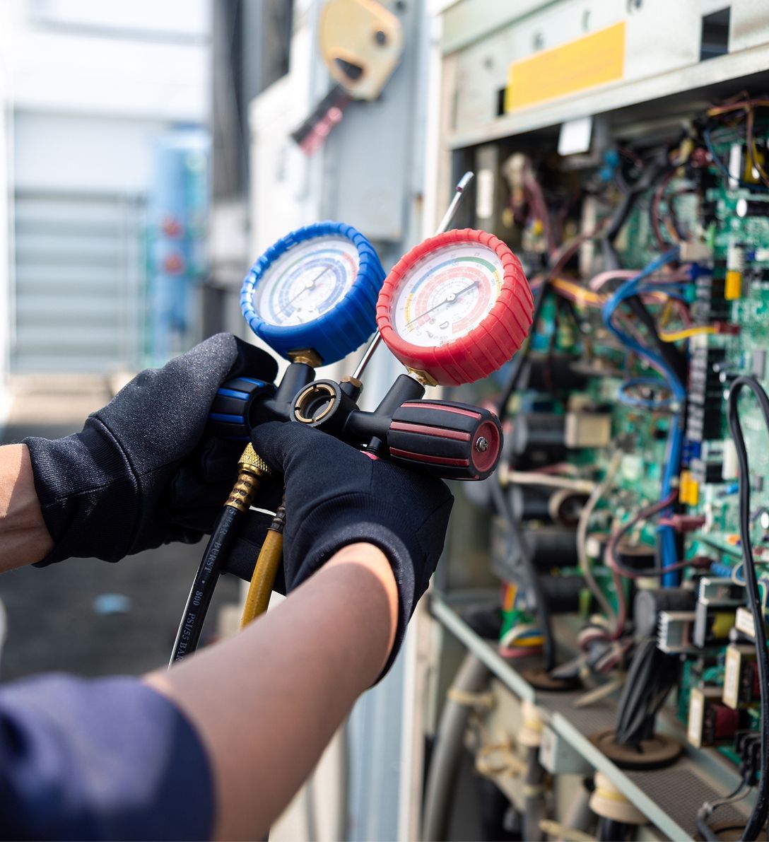 A person is working on a machine with two gauges on it.