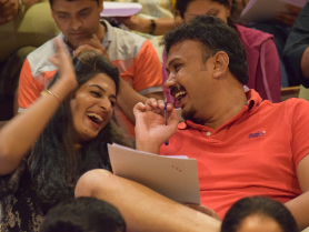 laughter—partners sharing insights during interactive couples coaching
