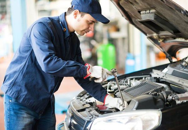 mechanic tuning an engine mechanic tuning an engine