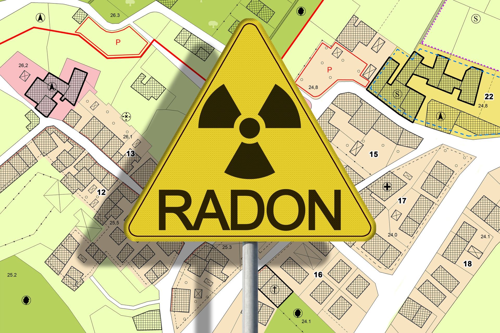 Yellow radon hazard sign over a map of a town.