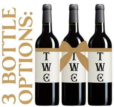 Three dark wine bottles with blank white labels on a white background