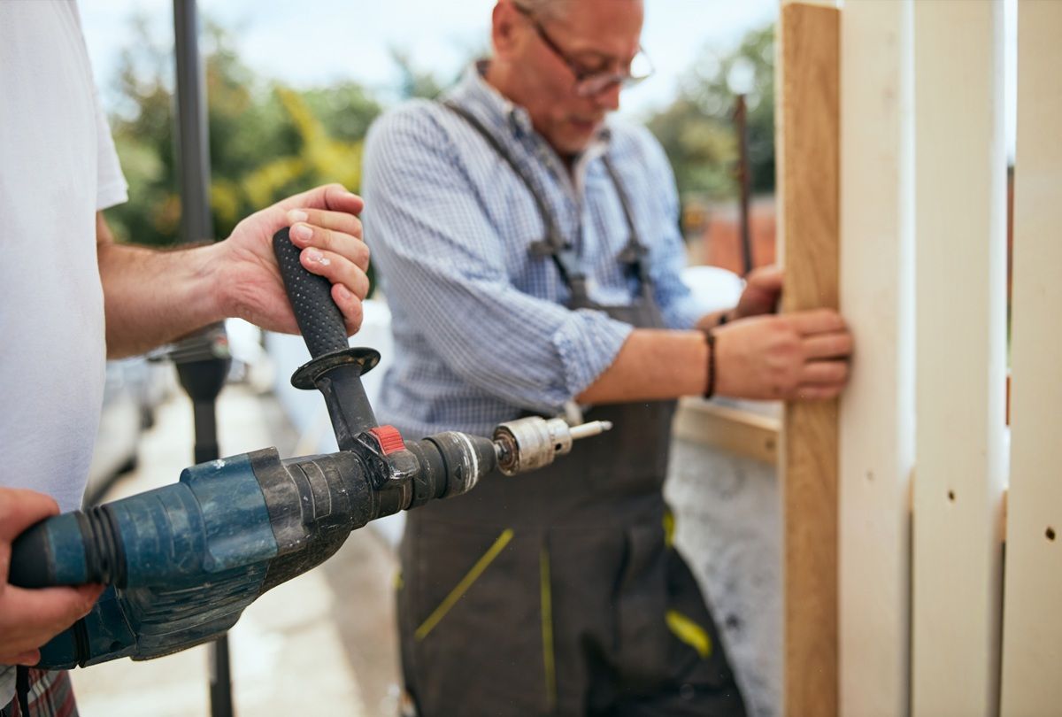 Garage door technician repairing a residential garage door in Hanford, CA
