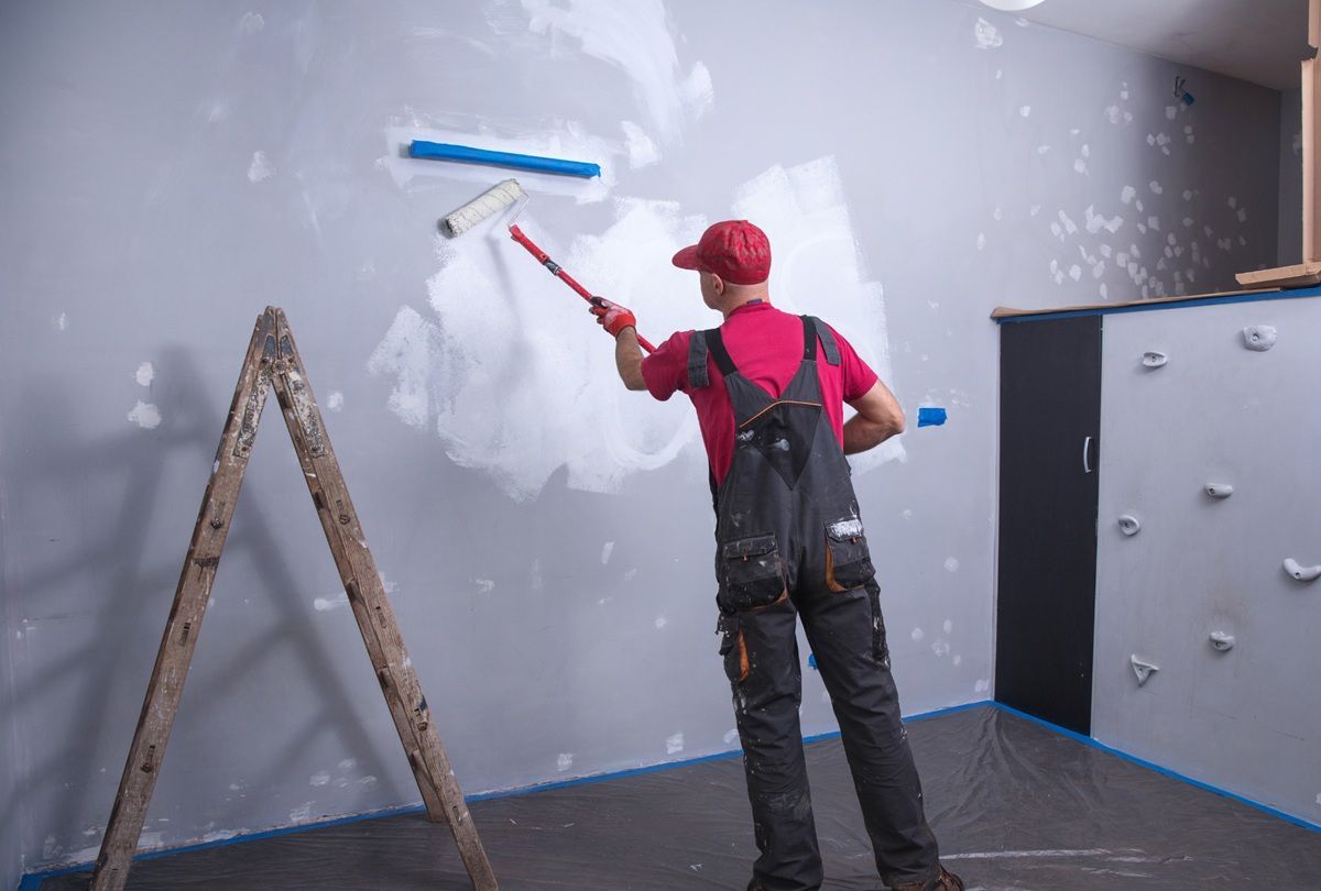 House painter applying a fresh coat of paint to a Hanford, CA home
