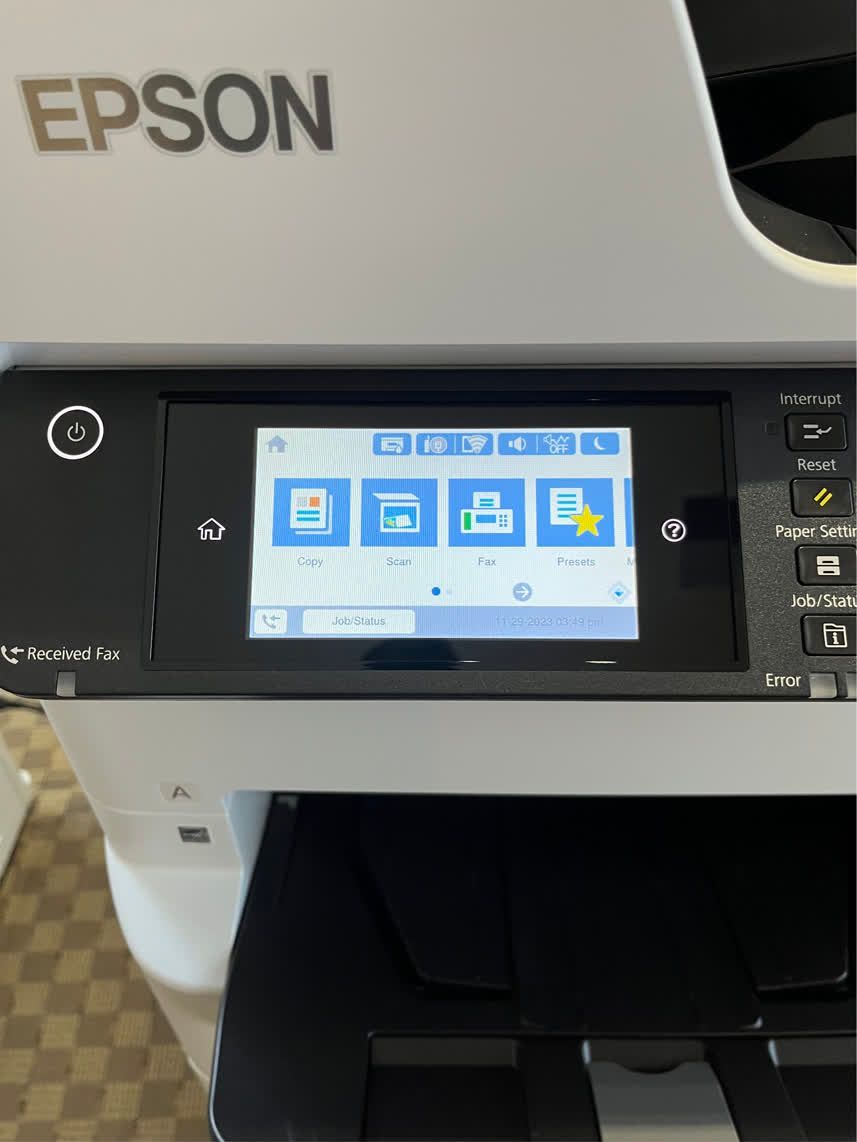 Epson printer control panel displaying icons for copy, scan, fax, and shortcuts on a touchscreen.