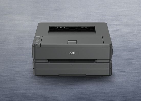 Gray laser printer on a gray surface; front view.